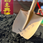 新業(yè)建設(shè) 穆椿松 創(chuàng)辦人 於金鏟上簽名留念，開(kāi)工誌慶，步步啟程。