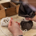 抓取藥材，包起、壓緊、編綁成球，感受草本植癒之外，還增添了另一份手感溫度，透過(guò)捶打、按壓，舒緩疲勞、釋放壓力。